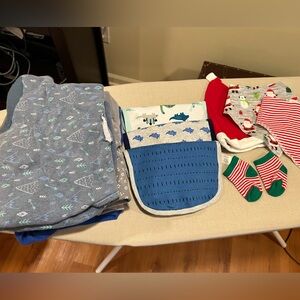 Assortment of new born essentials, 5 bibs, 5 swaddles, 1 hat and 1 pair socks.